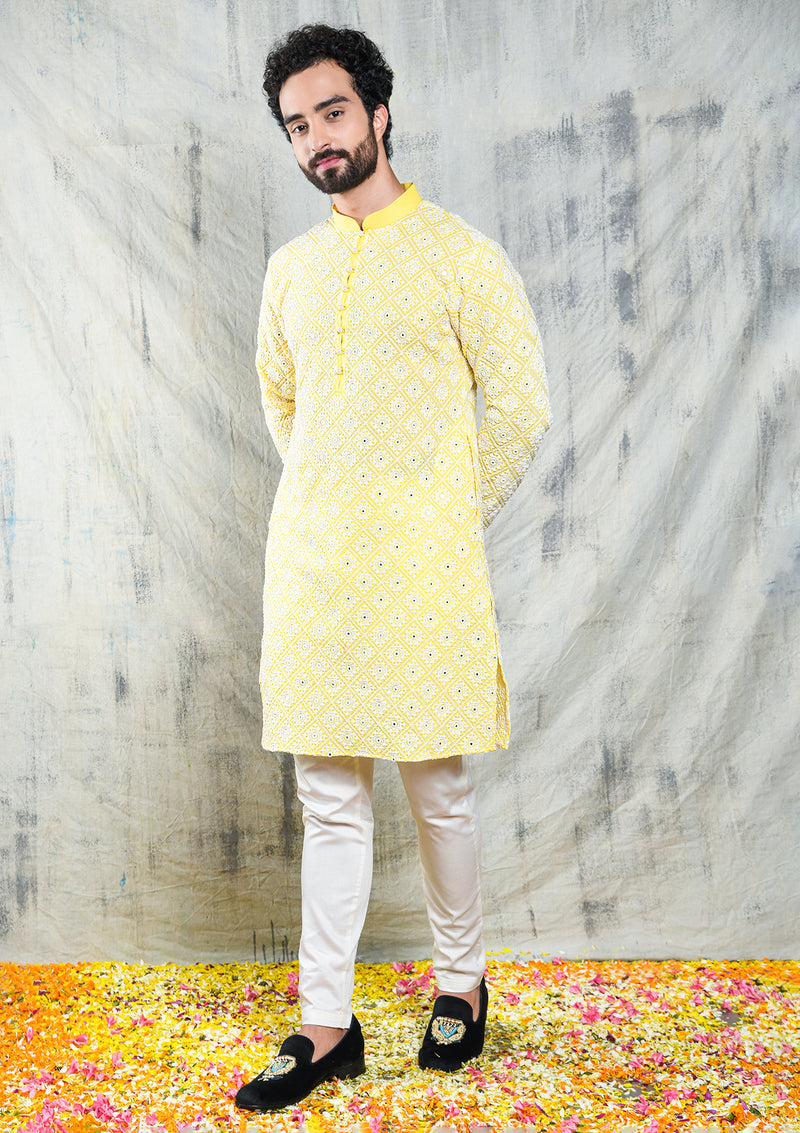 Front view of Be Desi men's mirror work haldi yellow kurta pajama set